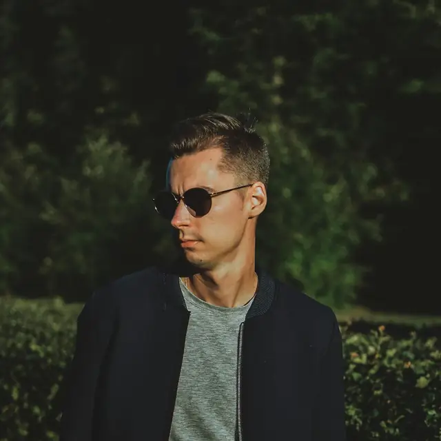 Man in a navy jacket and sunglasses