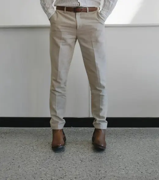 Cream tailored trousers with brown leather boots