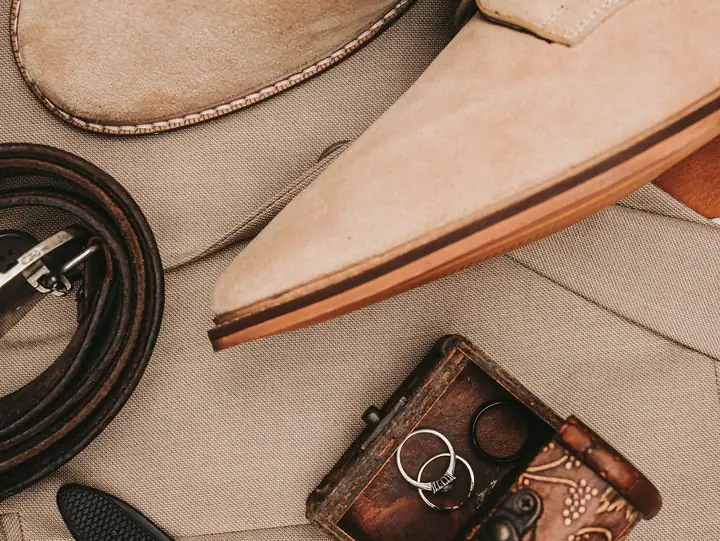 Suede shoes, leather belt and watch flat lay